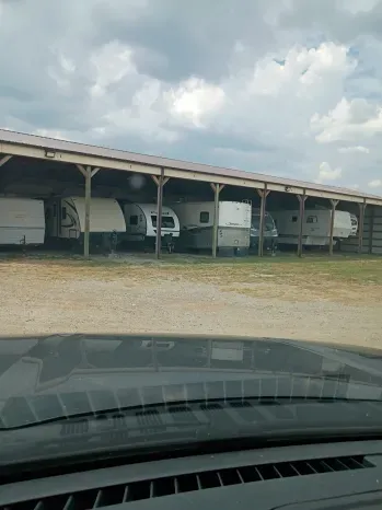 Covered canopy bays with RVs parked at Quiet Stay RV Park in Morrison, OK